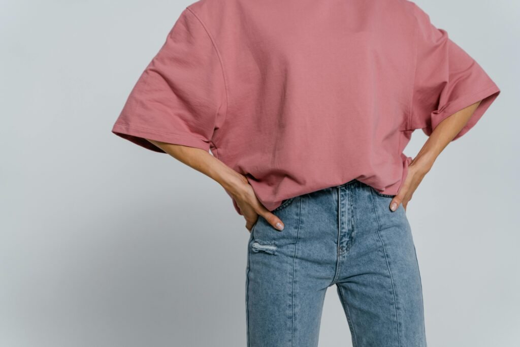 Casual pink t-shirt with jeans in a minimalist studio shot showcasing fashion style.